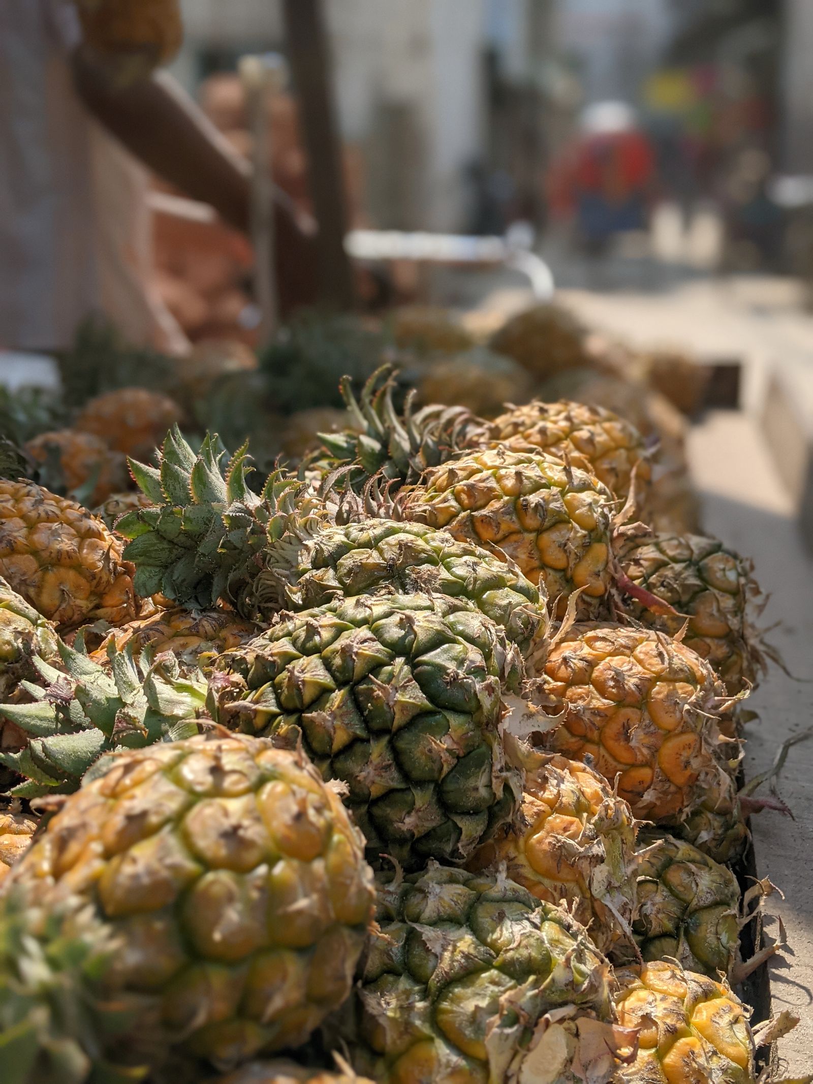 Fresh pineapples on an outdoor market stall