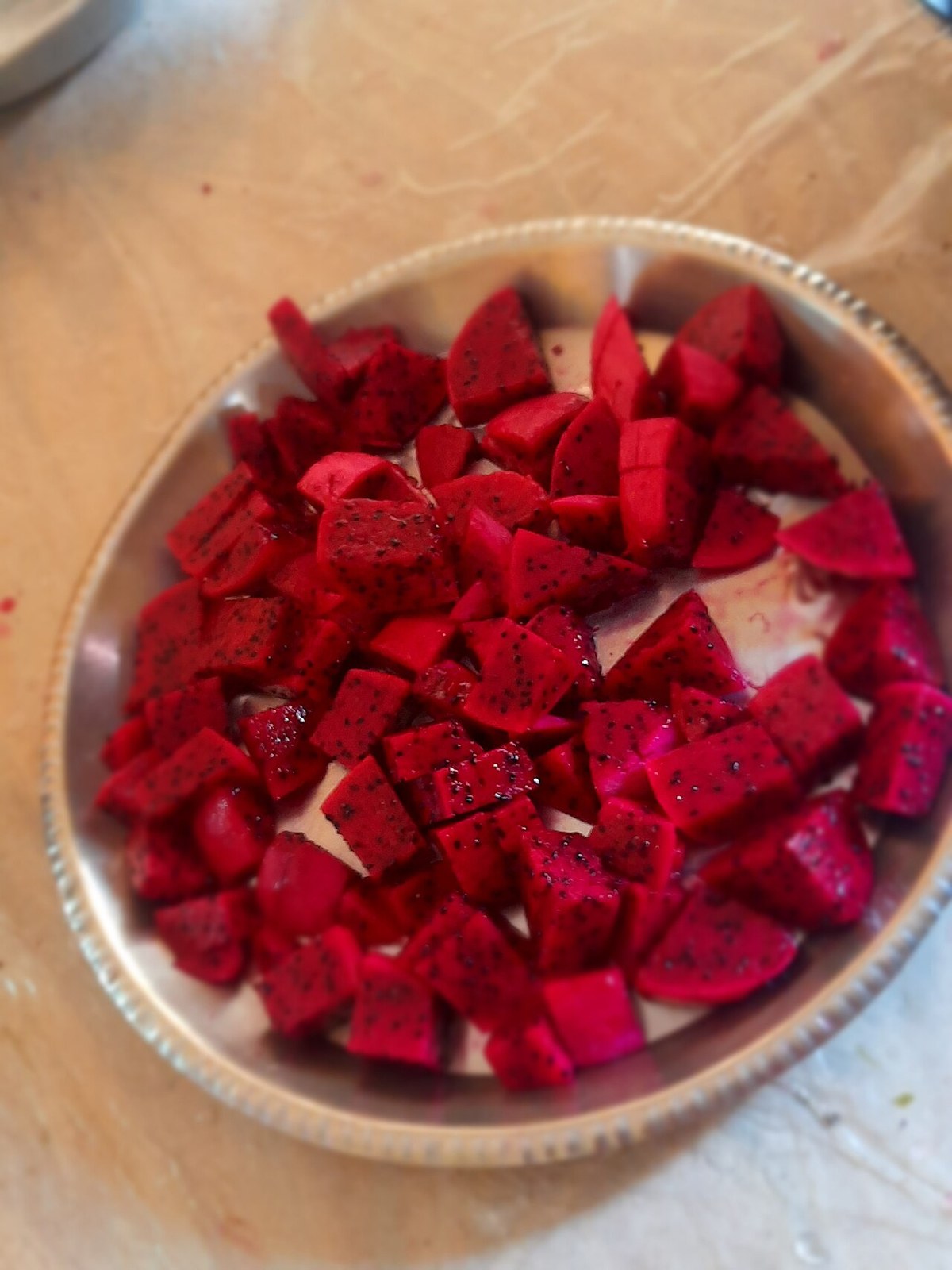 Red-flesh dragon fruit cut into small cubes in a bowl.