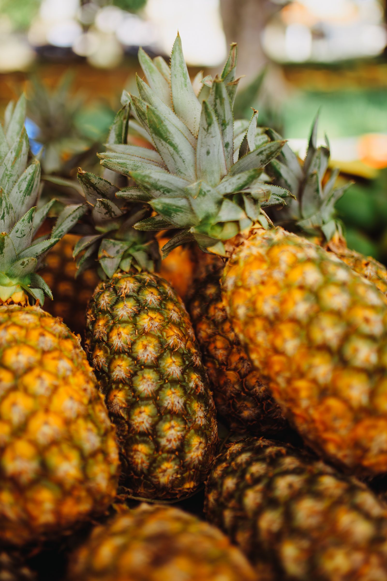 Fresh pineapples stacked at a market