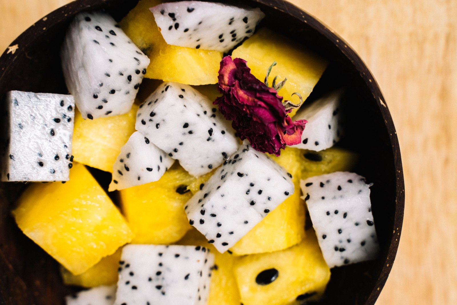 White-flesh dragon fruit cubes with pineapple pieces in a bowl.