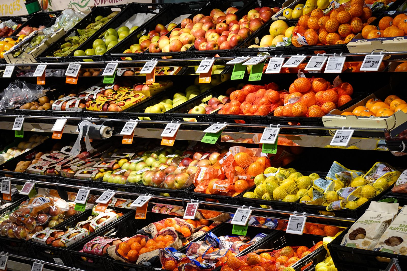 Assorted fresh fruits arranged on supermarket shelves